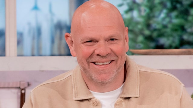 Tom Kerridge in a cream jacket in a kitchen