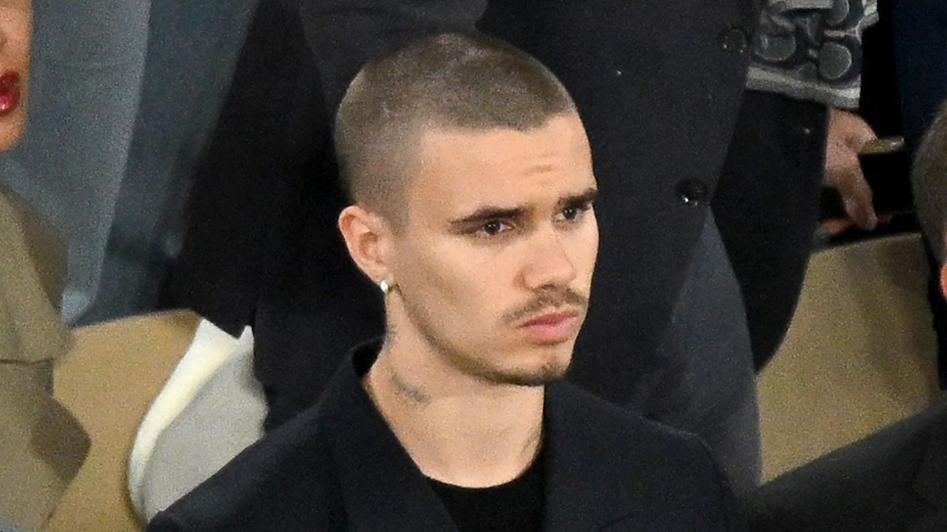 Romeo Beckham with a blank expression