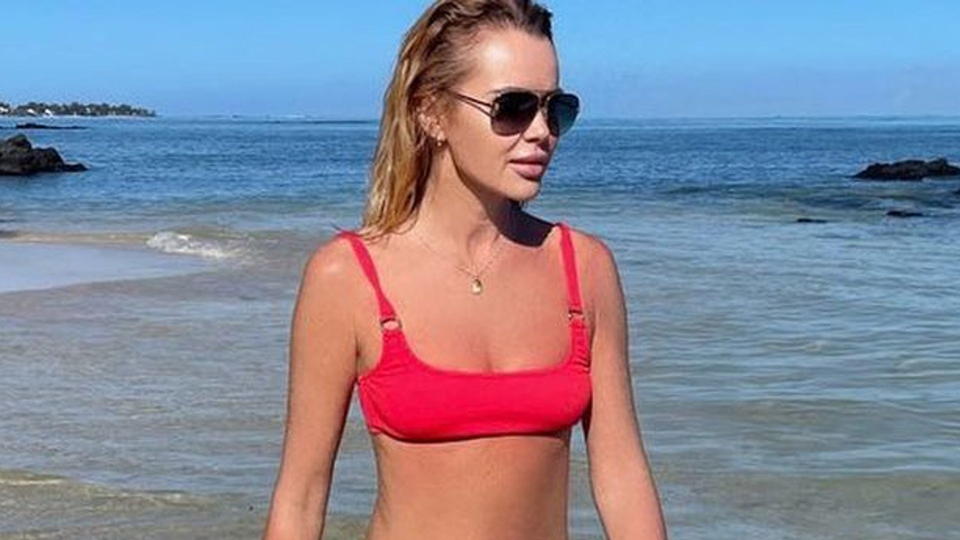 Amanda Holden wearing a red bikini