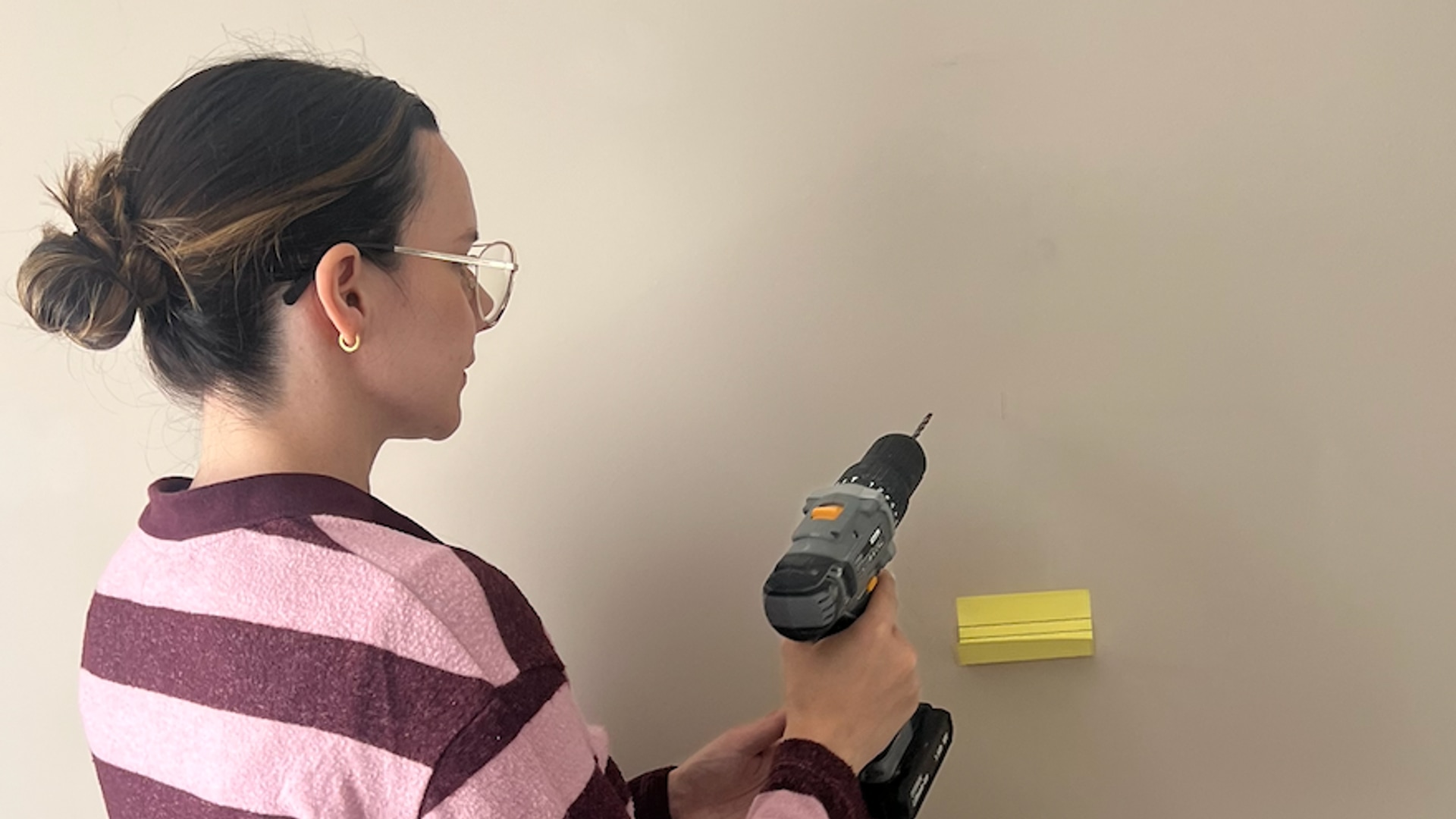 woman in striped top with drill