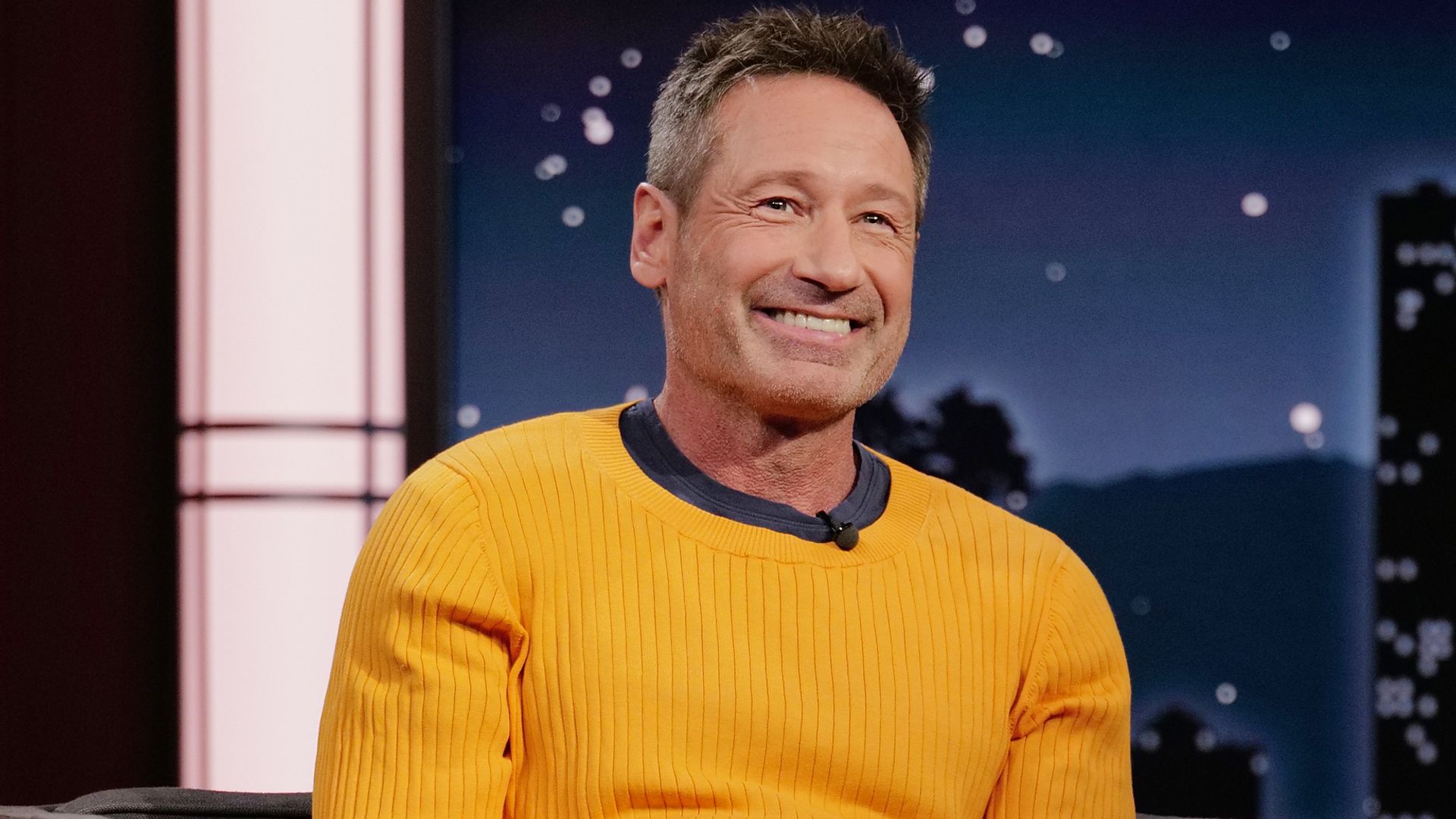 David Duchovny sat smiling while appearing on Jimmy Kimmel live in 2022