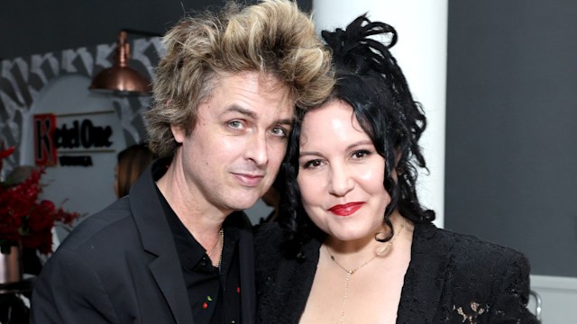 photo of billie joe armstrong and wife adrienne smiling with heads together