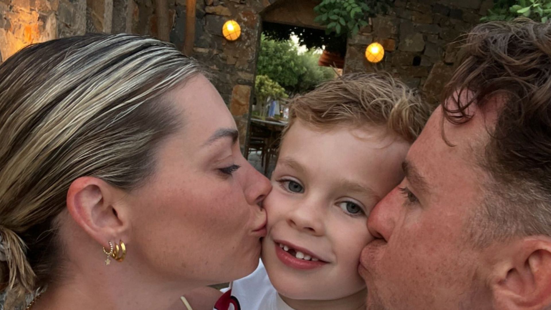 Georgia Horsley and Danny Jones kissing their son