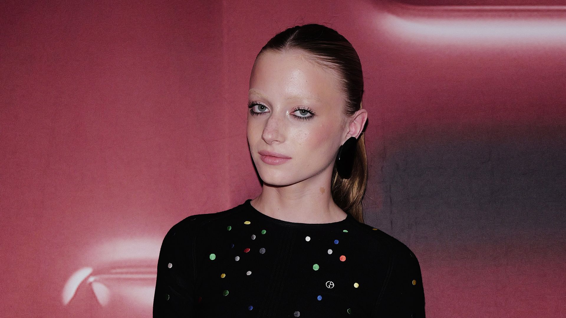 kai schreiber black dress pink background