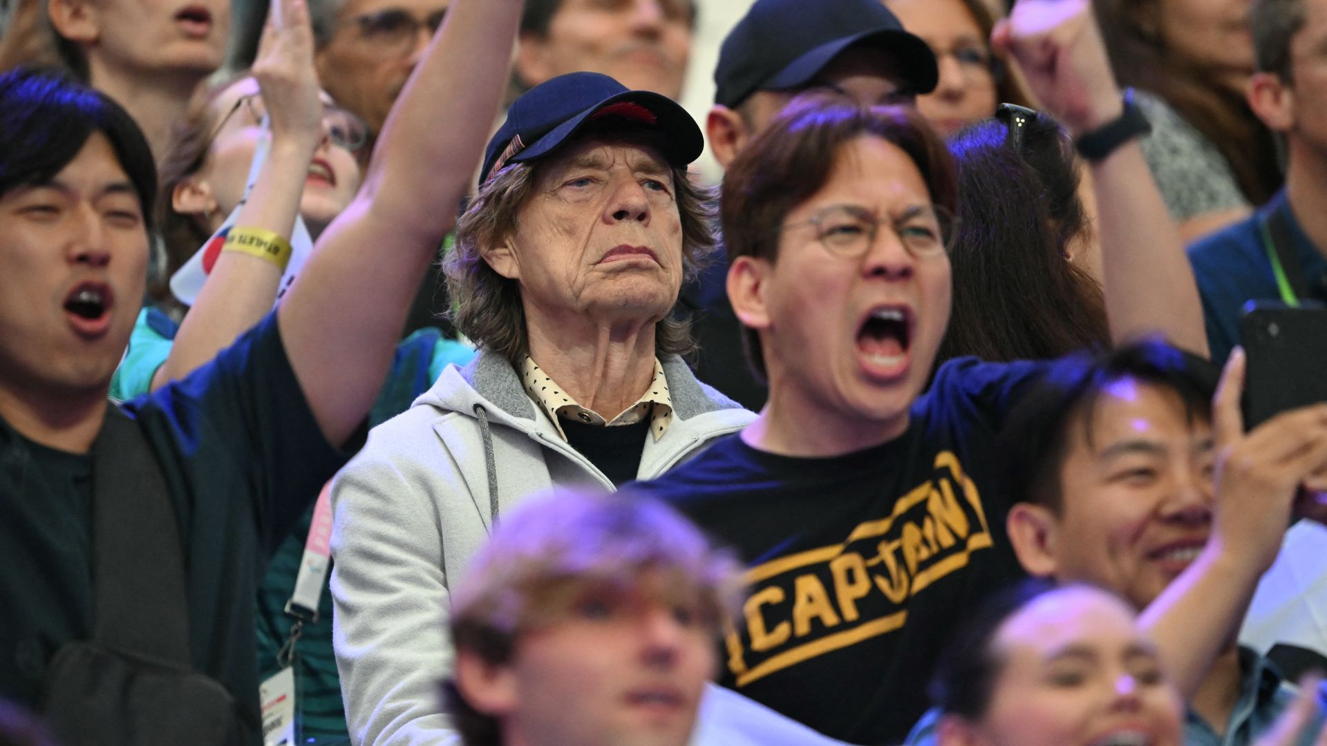 British singer Sir Mick Jagger (C) of The Rolling Stones attends fencing competitions during the Paris 2024 Olympic Games at the Grand Palais in Paris, on July 27, 2024. 