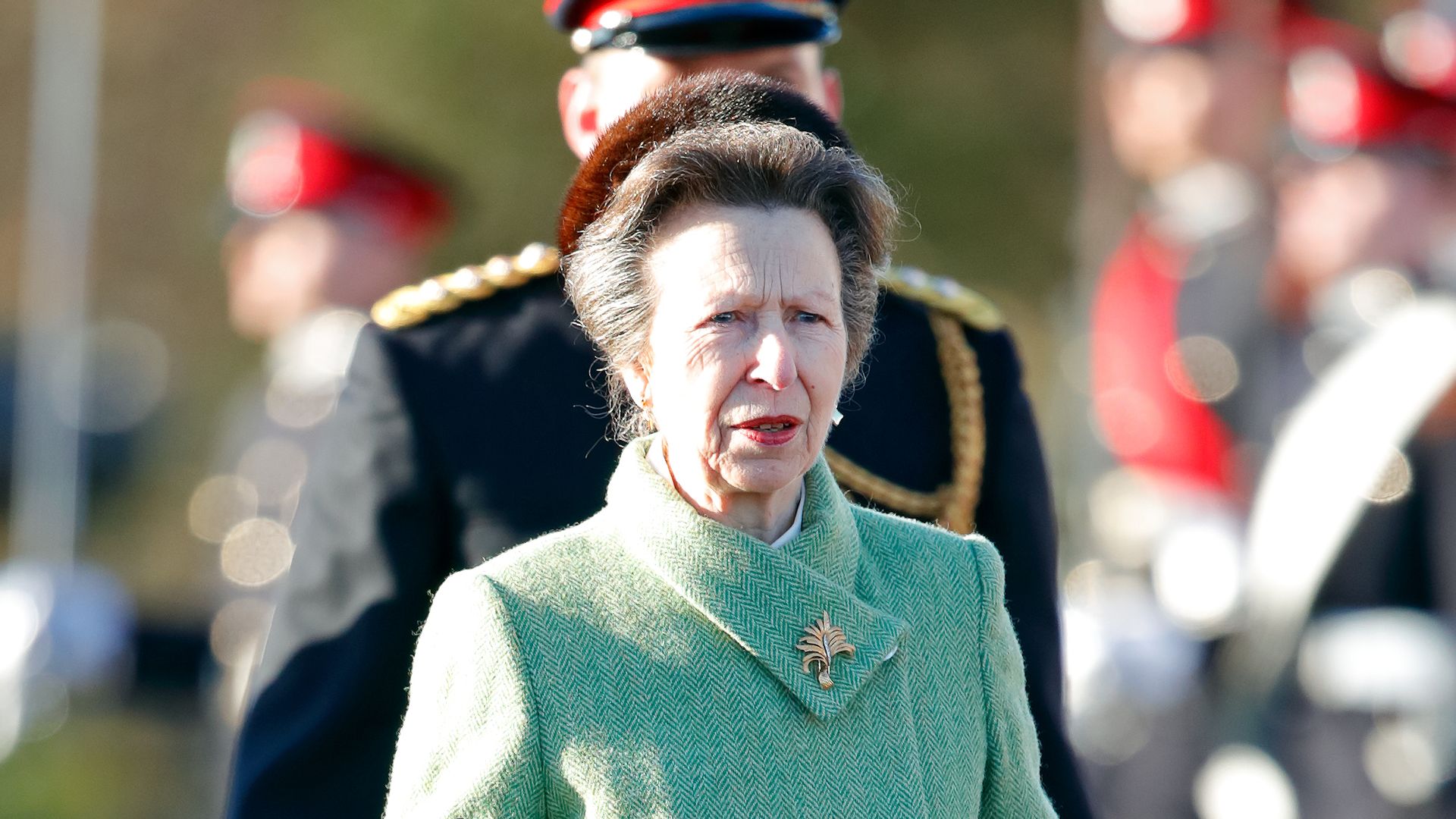 Princess Anne in knee-high boots and seafoam green coat