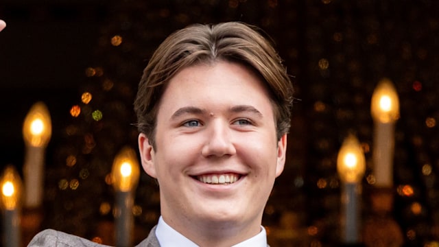 man waving in suit and tie