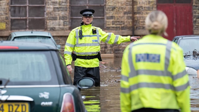 Police officer wading through water