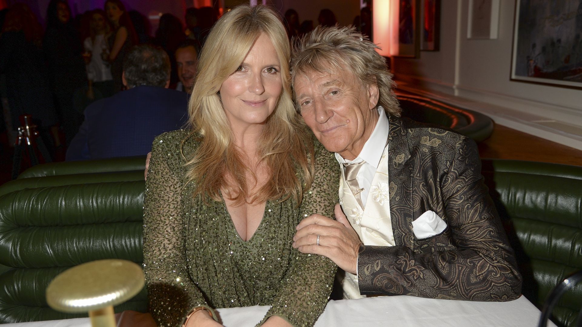 Penny Lancaster in green dress and Rod Stewart in suit