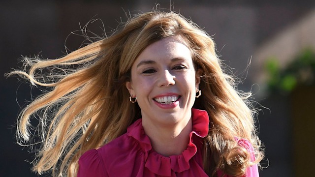 Carrie Johnson walking in a pink dress