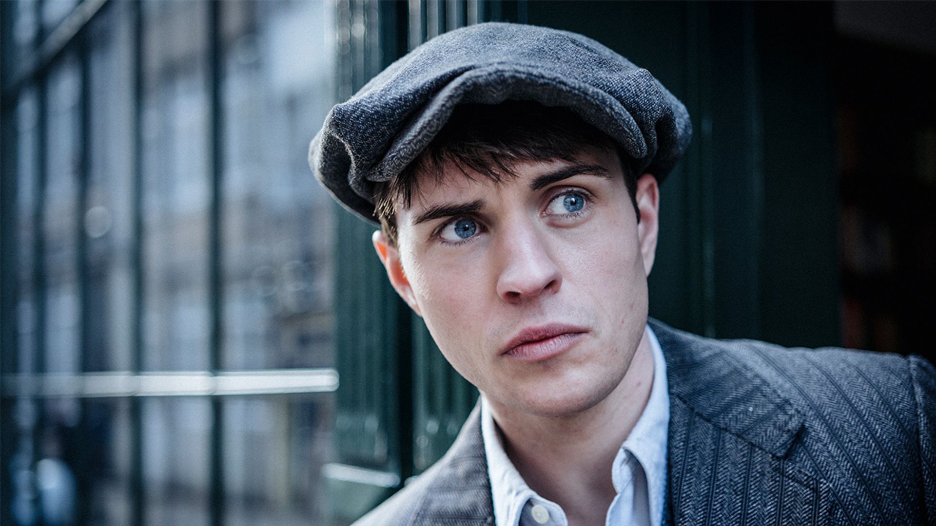 close-up man in grey cap and suit