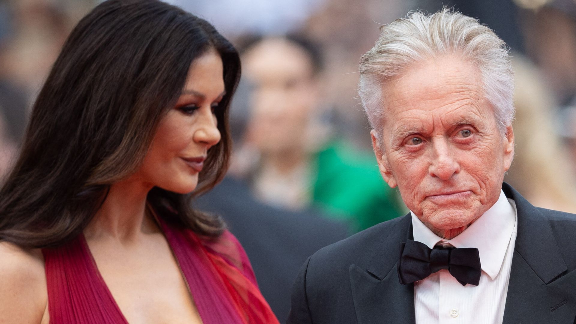 Catherine Zeta-Jones in a red dress with her husband Michael Douglas on the red carpet