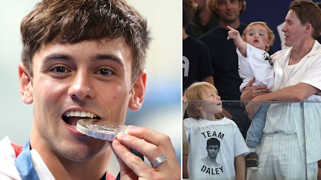 Tom Daley biting his silver medal and his husband with his two sons