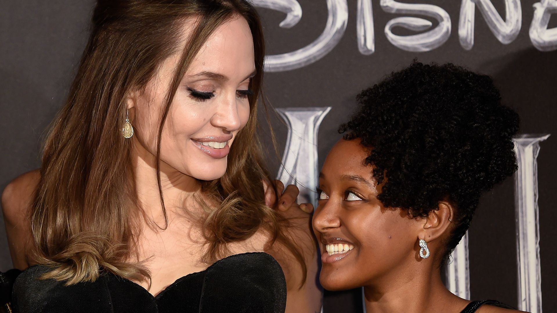 Angelina and Zahara smiling at each other at the premiere for Maleficent 2