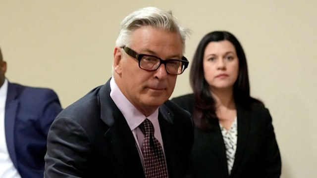 Actor Alec Baldwin leans on a chair during a break in his hearing in Santa Fe County District Court, July 10, 2024