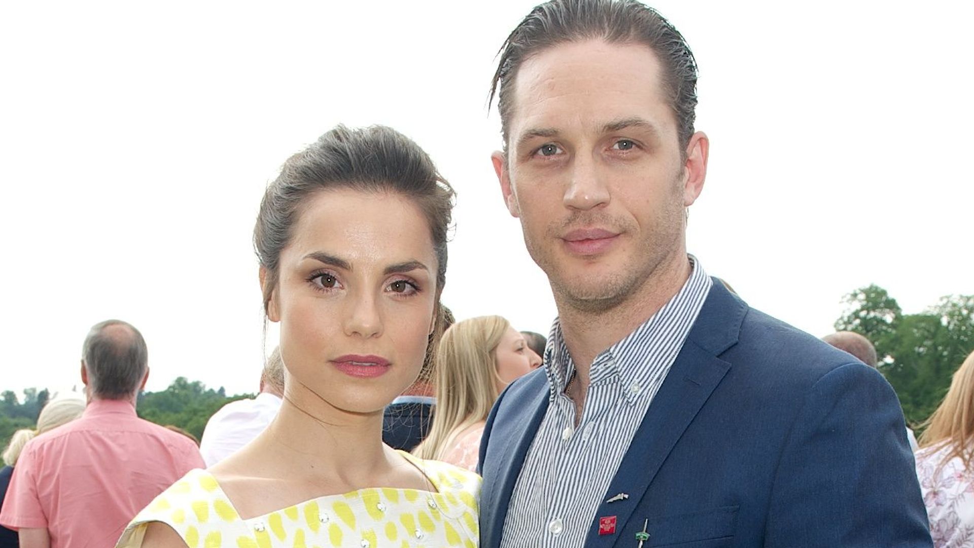 Charlotte Riley in a yellow dress with Tom Hardy in a blue jacket
