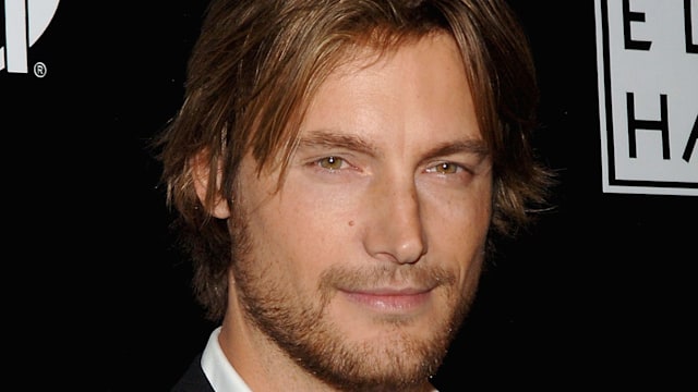 Gabriel Aubry smiling in a dapper suit 