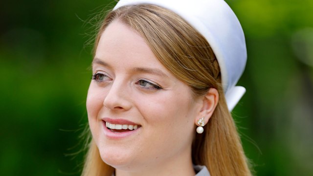 Flora Vesterberg looking to side in lace dress and white headband