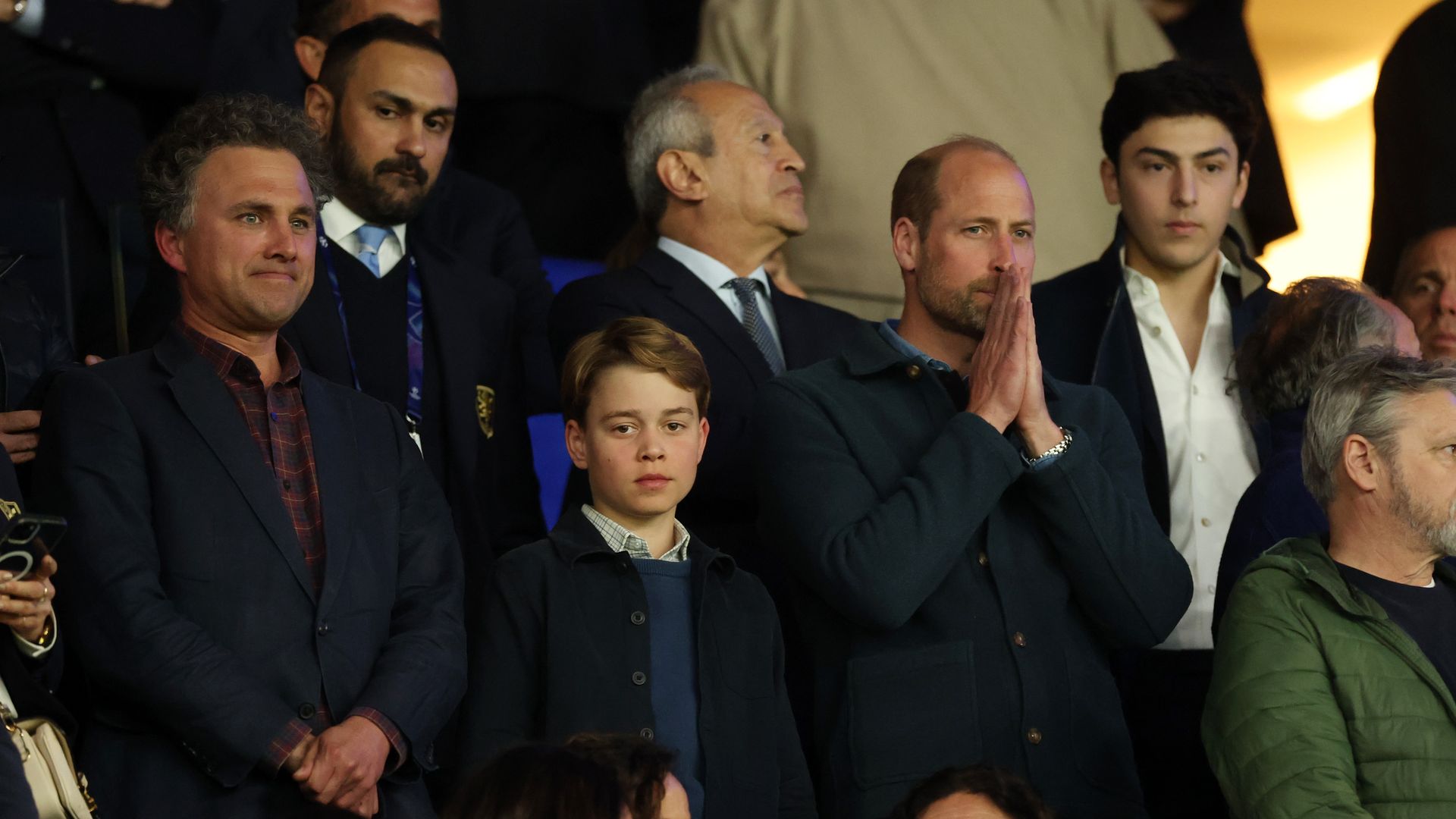 Thomas van Straubenzee, Prince George of Wales and Prince William, Prince of Wales react from the stands during the UEFA Champions League 2024/25 Quarter Final First Leg match between Paris Saint-Germain and Aston Villa FC at Parc des Princes on April 09, 2025 in Paris, France.
