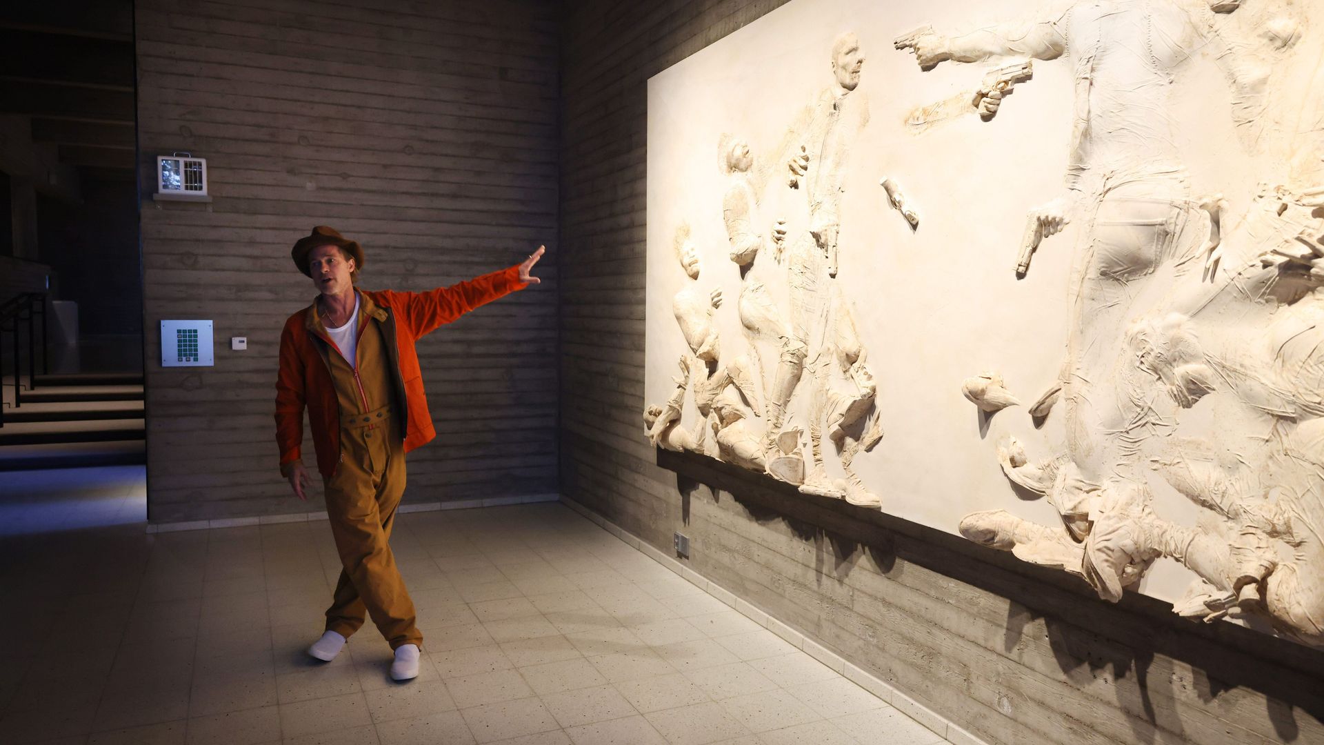 man pointing at art installation