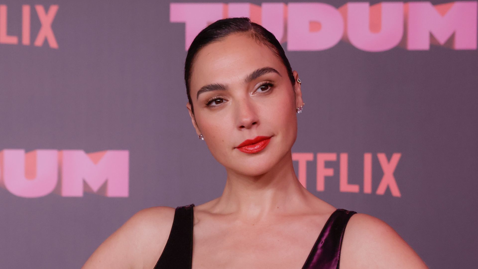 Gal Gadot displays svelte physique in skin tight plunging leather dress