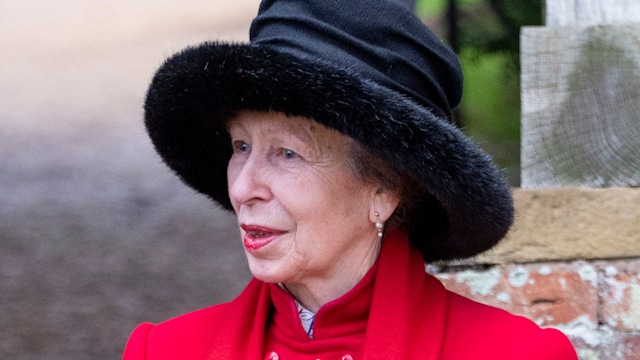 Princess Anne in a red jacket and a black hat