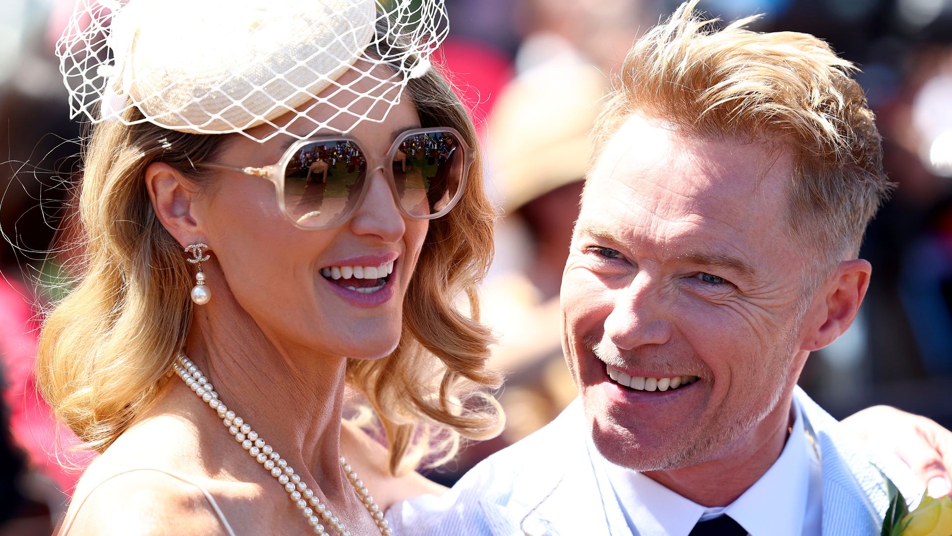 Storm Keating in sunglasses and a birdcage veil with Ronan