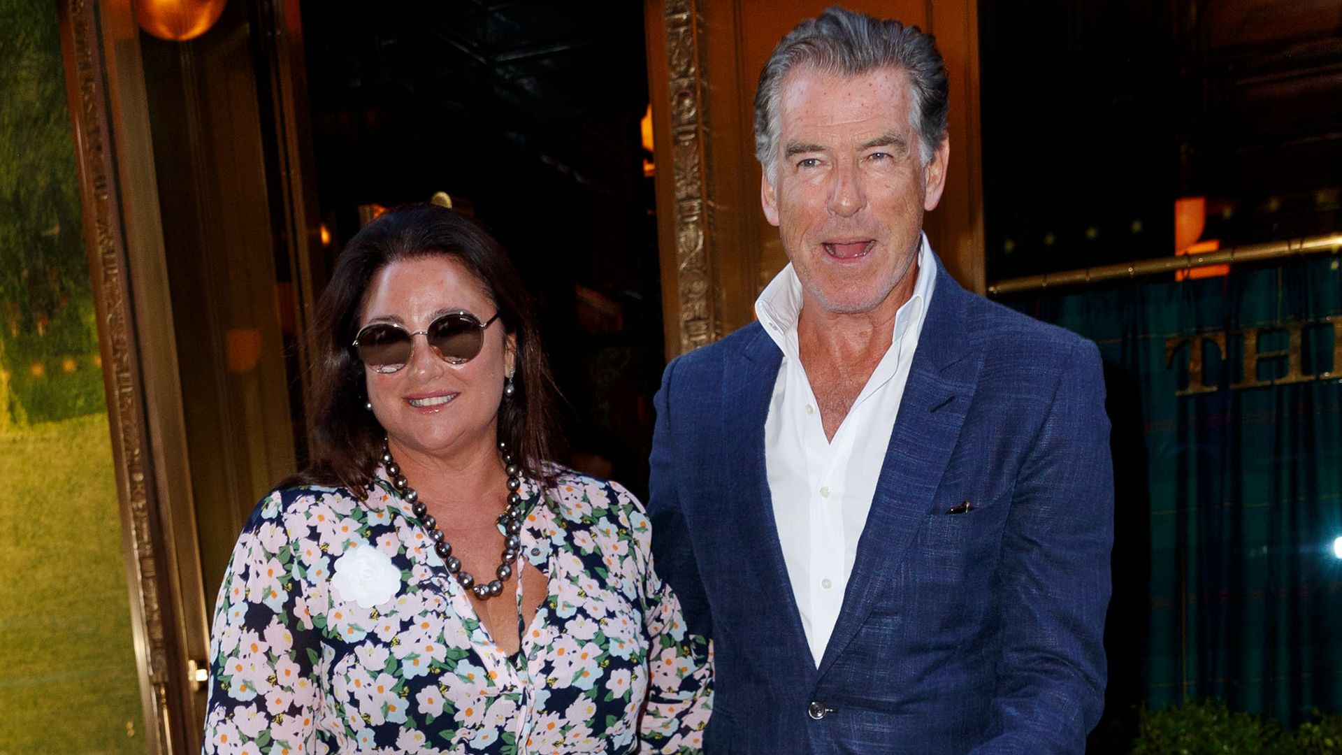 pierce brosnan and keely shaye exiting building smiling
