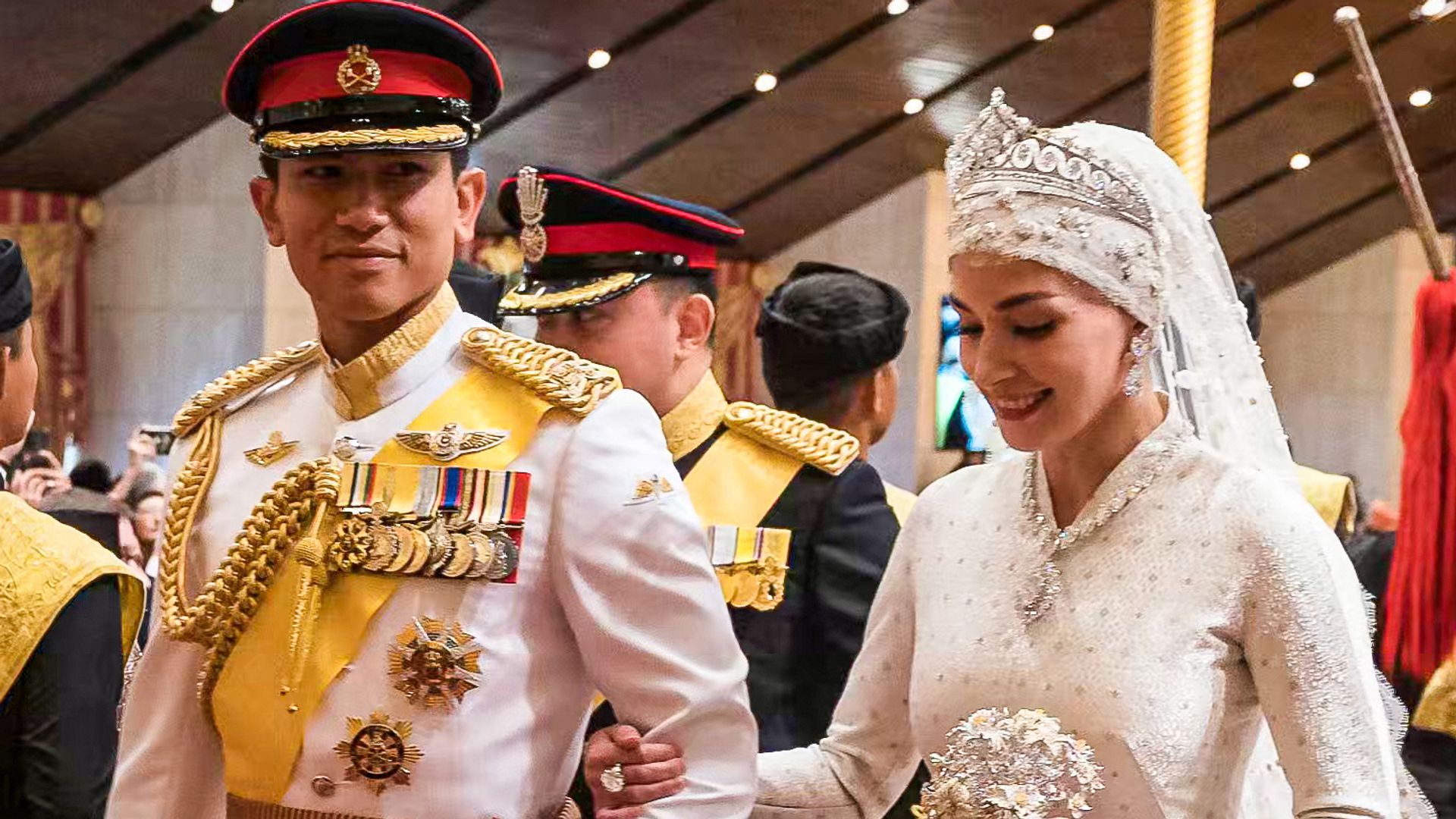 Prince Abdul Mateen and Yang Mulia Anisha Rosnah walk down the aisle during their wedding reception