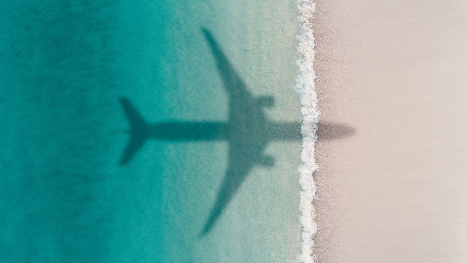 Aeroplane flying over a Barbados beach