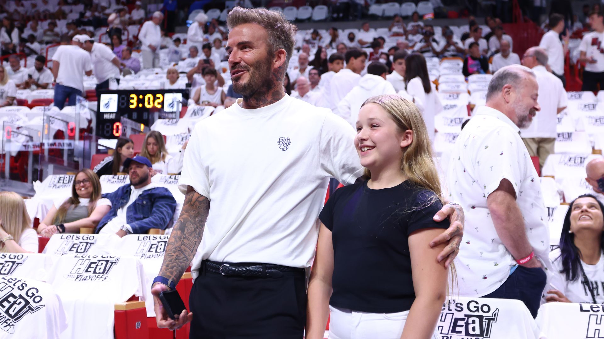 David Beckham with his arm around Harper Beckham