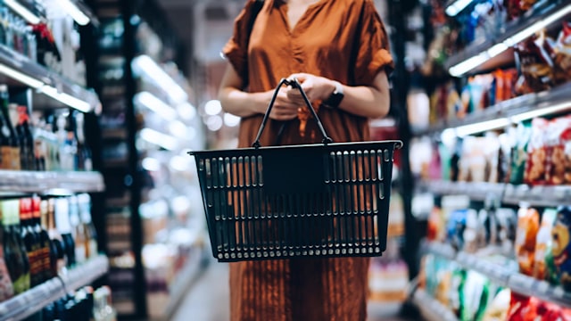 young woman carrying shopping basket