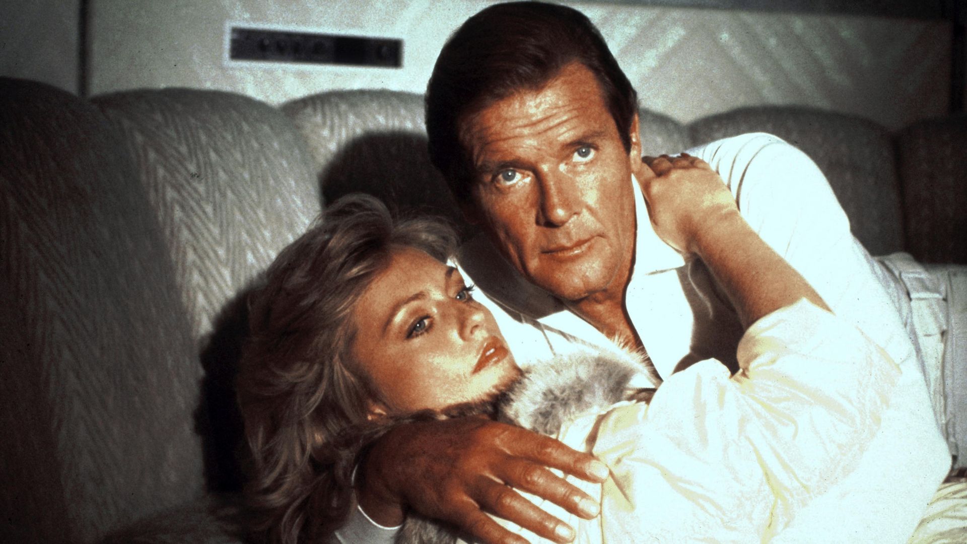 Roger Moore and Mary Stavin embracing in A View to a Kill