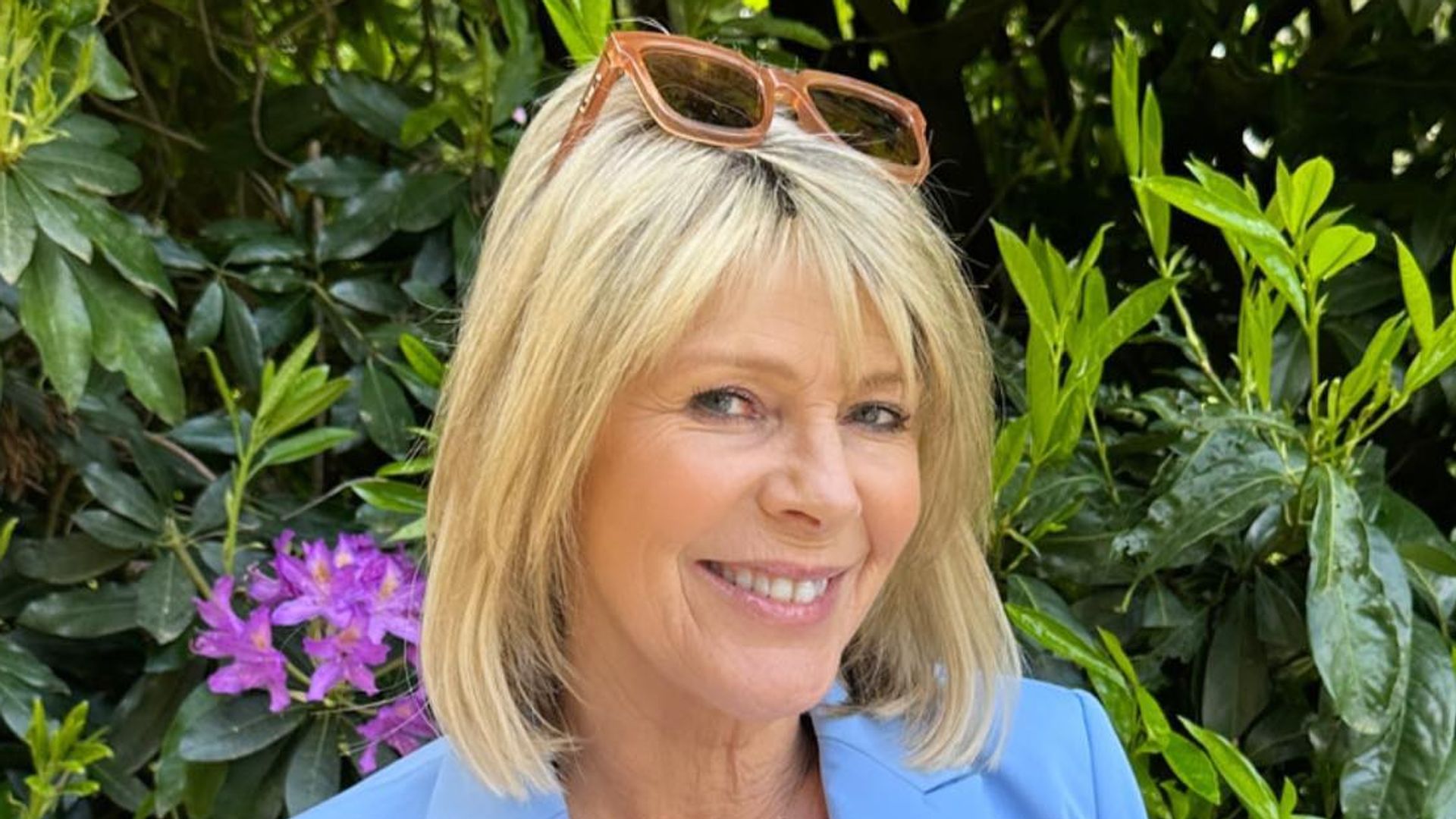 Ruth Langsford wearing blue blazer posing in garden of home with Eamonn Holmes 