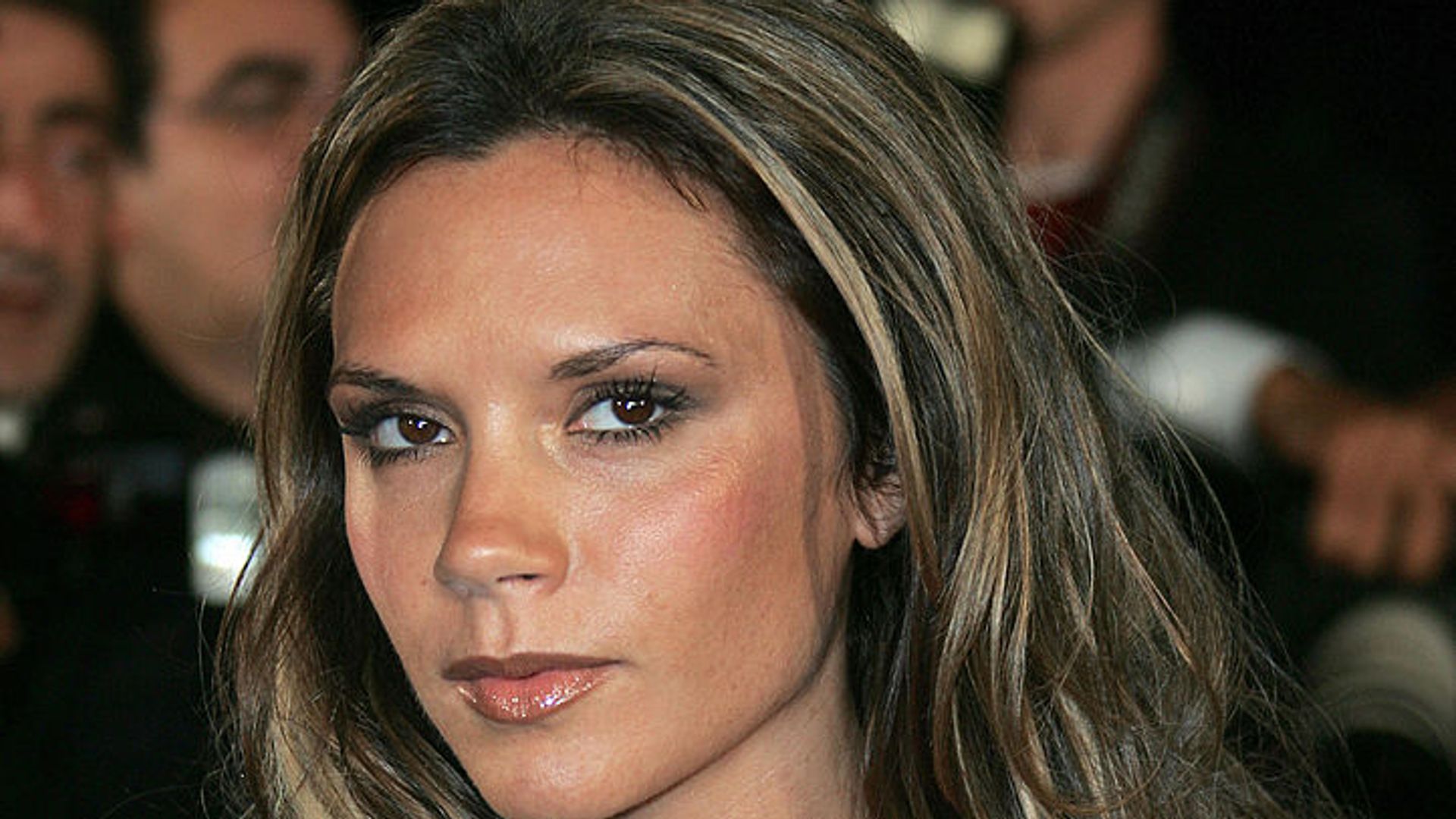 Victoria Beckham blue dress and chunky gold necklace  