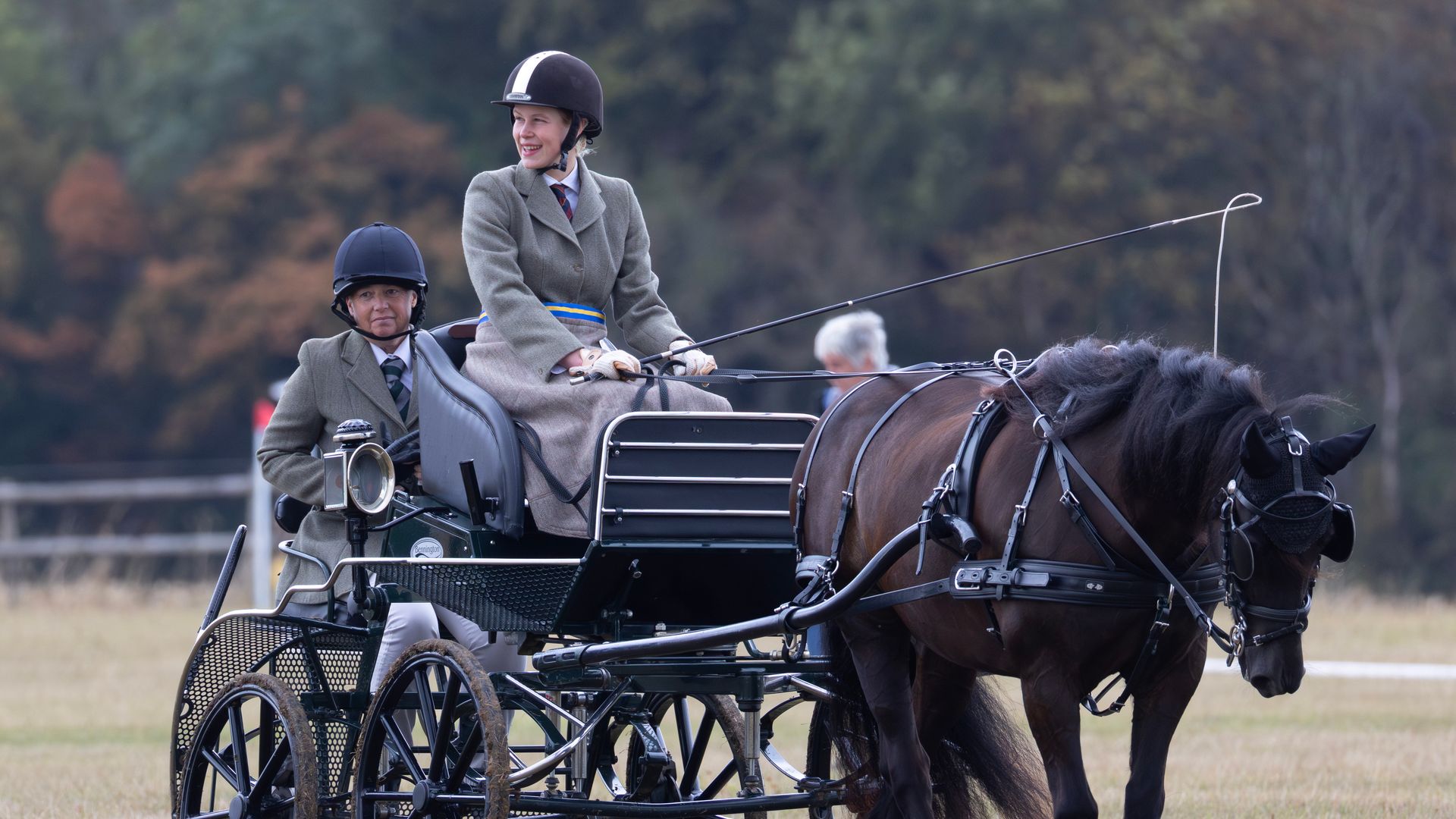 Lady Louise Windsor and another person riding in a carriage