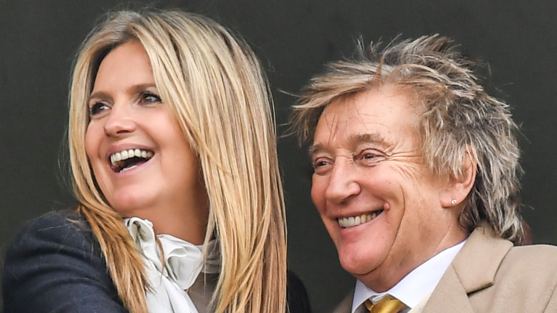 Rod Stewart and Penny Lancaster smiling at races