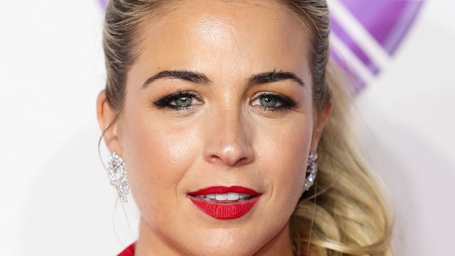 Gemma Atkinson wearing a red suit and red lip with hair up