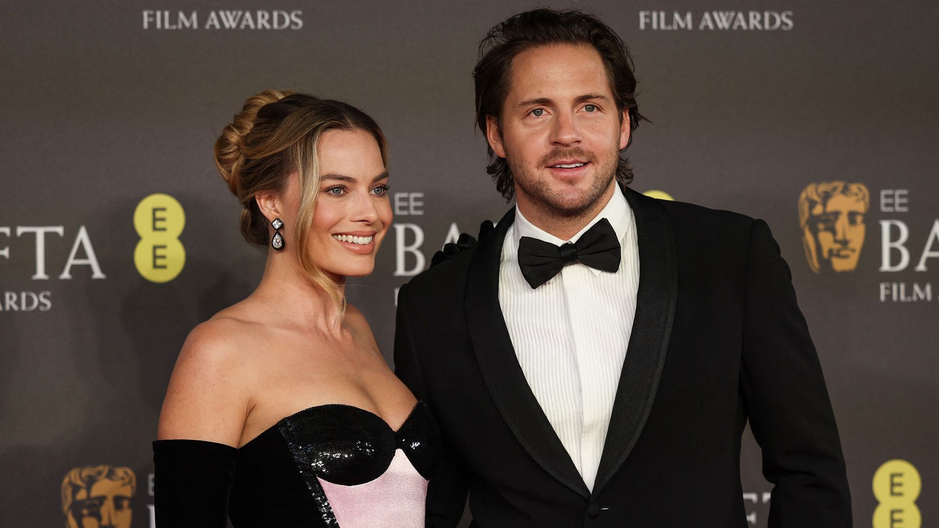 Australian actress Margot Robbie and English film producer Tom Ackerley pose on the red carpet upon arrival at the BAFTA British Academy Film Awards at the Royal Festival Hall, Southbank Centre, in London, on February 18, 2024