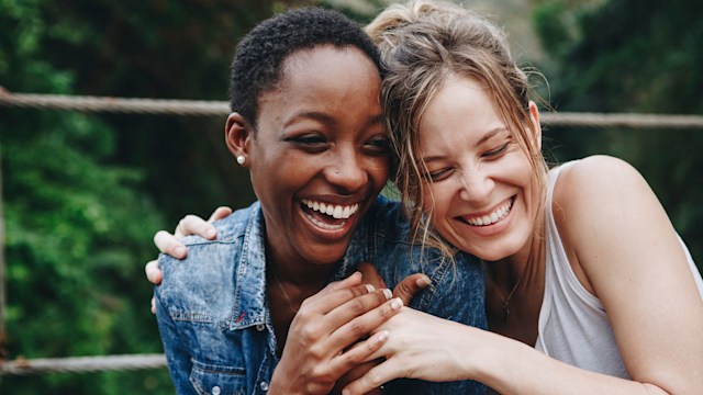 Two women hugging and laughing