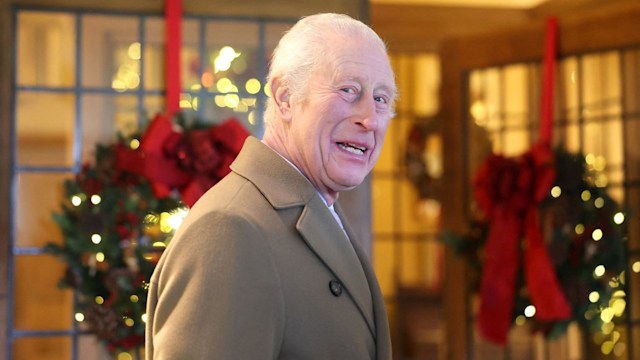 King Charles in front of Christmas wreaths at Highgrove