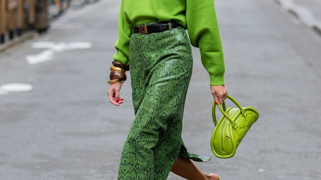 Nina Sandbech wears green top with long sleeves and bracelets Zara, skirt with snake print Gestuz, bag Mietis, shoes Prada, sunglasses Loewe during Womenswear Spring/Summer 2025 as part of  Paris Fashion Week on September 29, 2024 in Paris, France