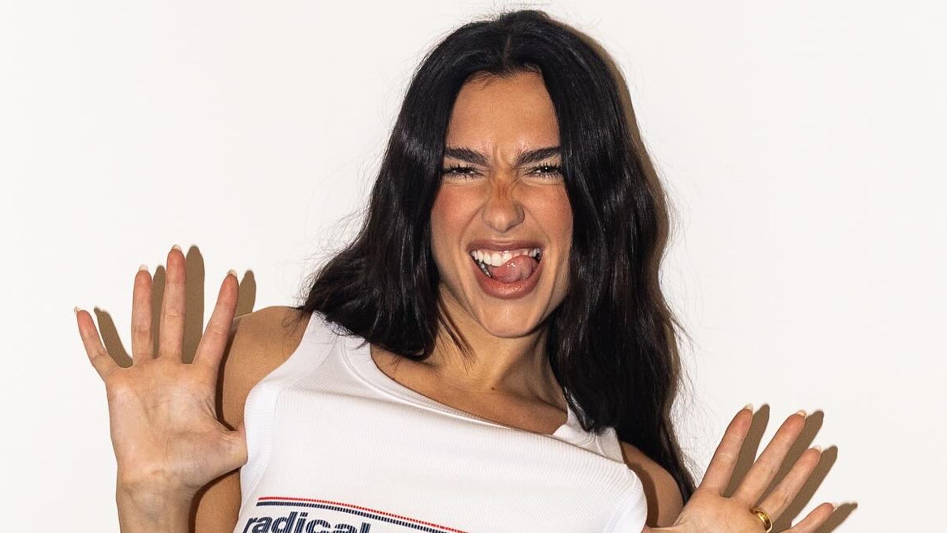 Dua Lipa poses in a white tank top on her Instagram