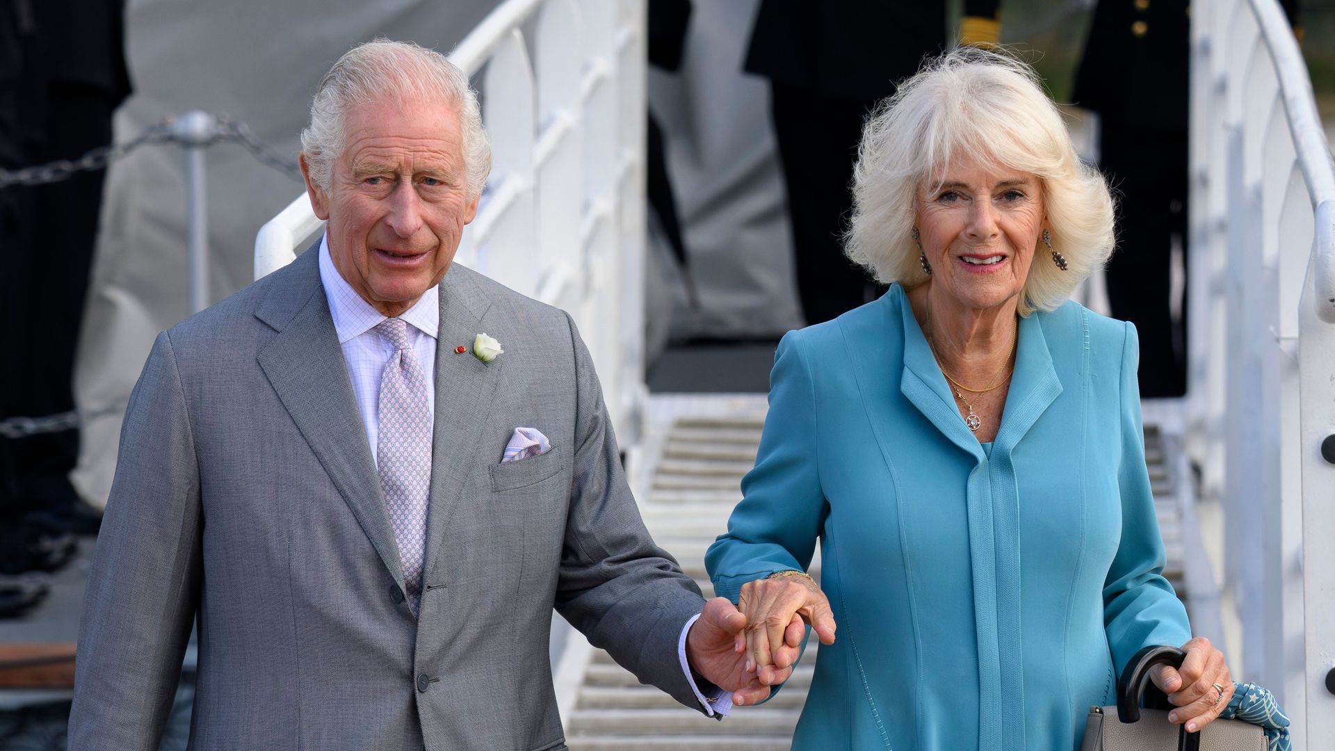 King Charles and Queen Camilla holding hands