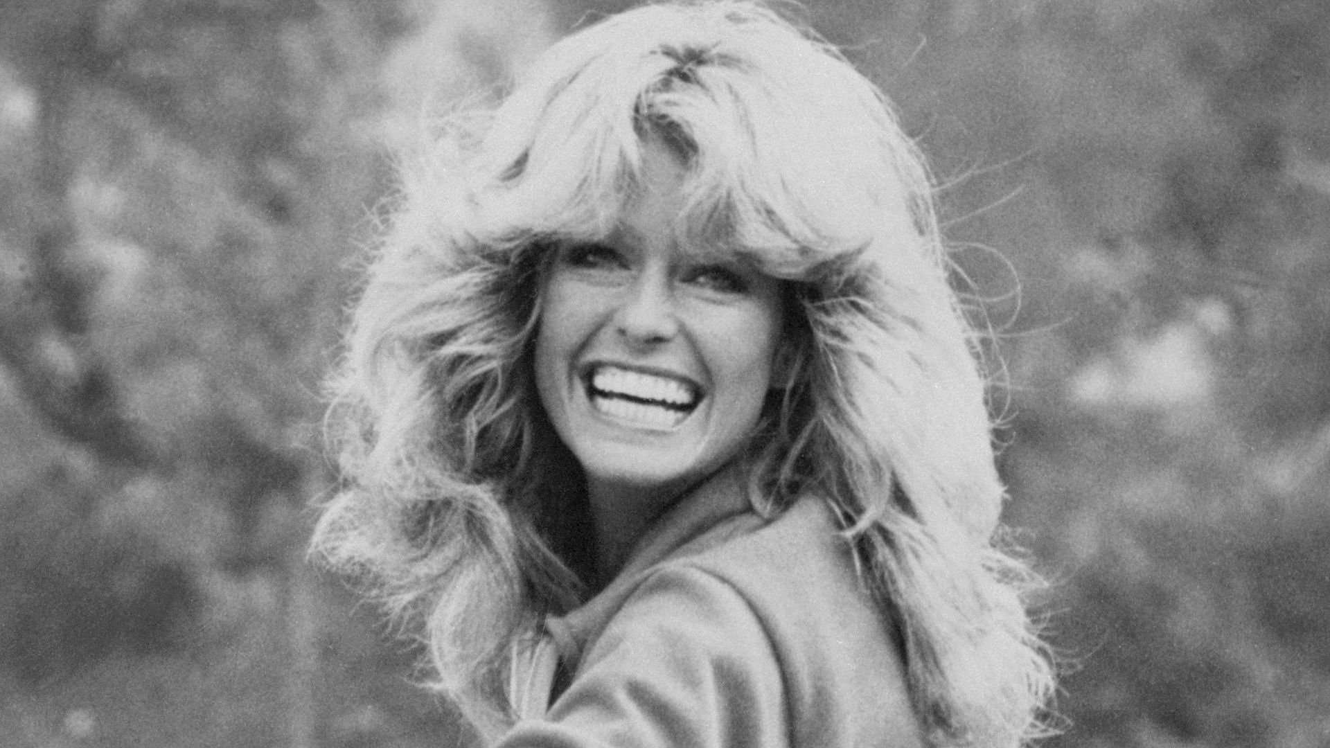 Actress Farrah Fawcett, wearing jeans, sweatshirt and Nike athletic shoes, practices skateboarding for an episode of Charlie's Angels.