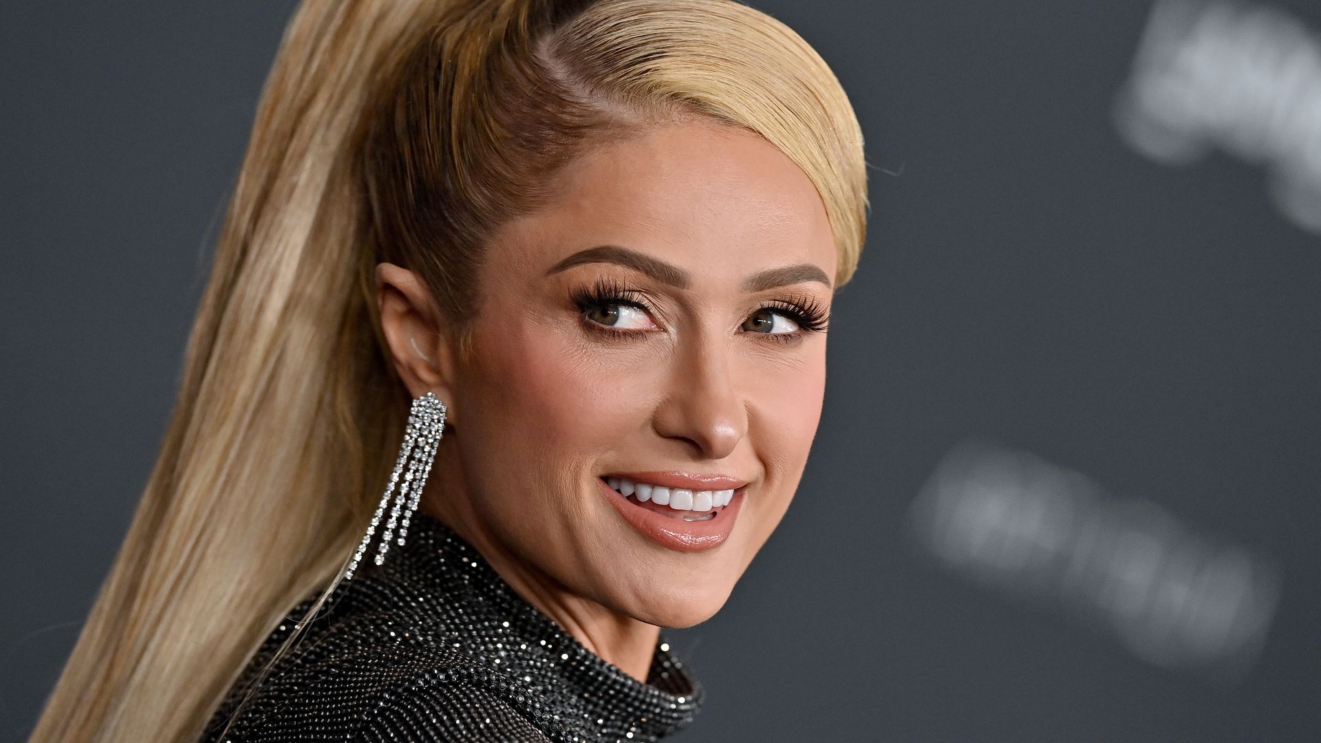 Paris Hilton looks phenomenal in lowcut sequin swimsuit in jaw