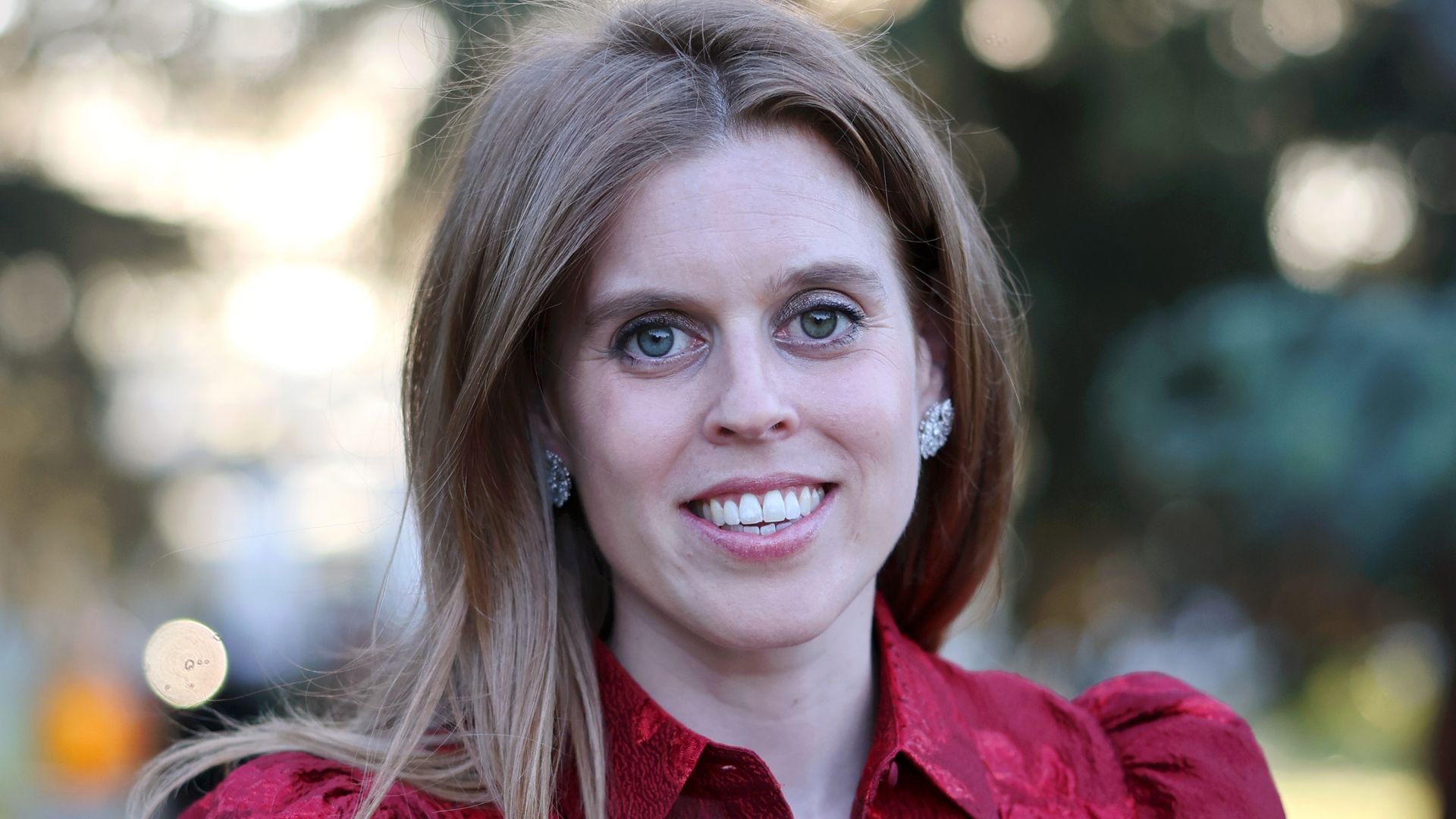 Princess Beatrice smiling in red dress