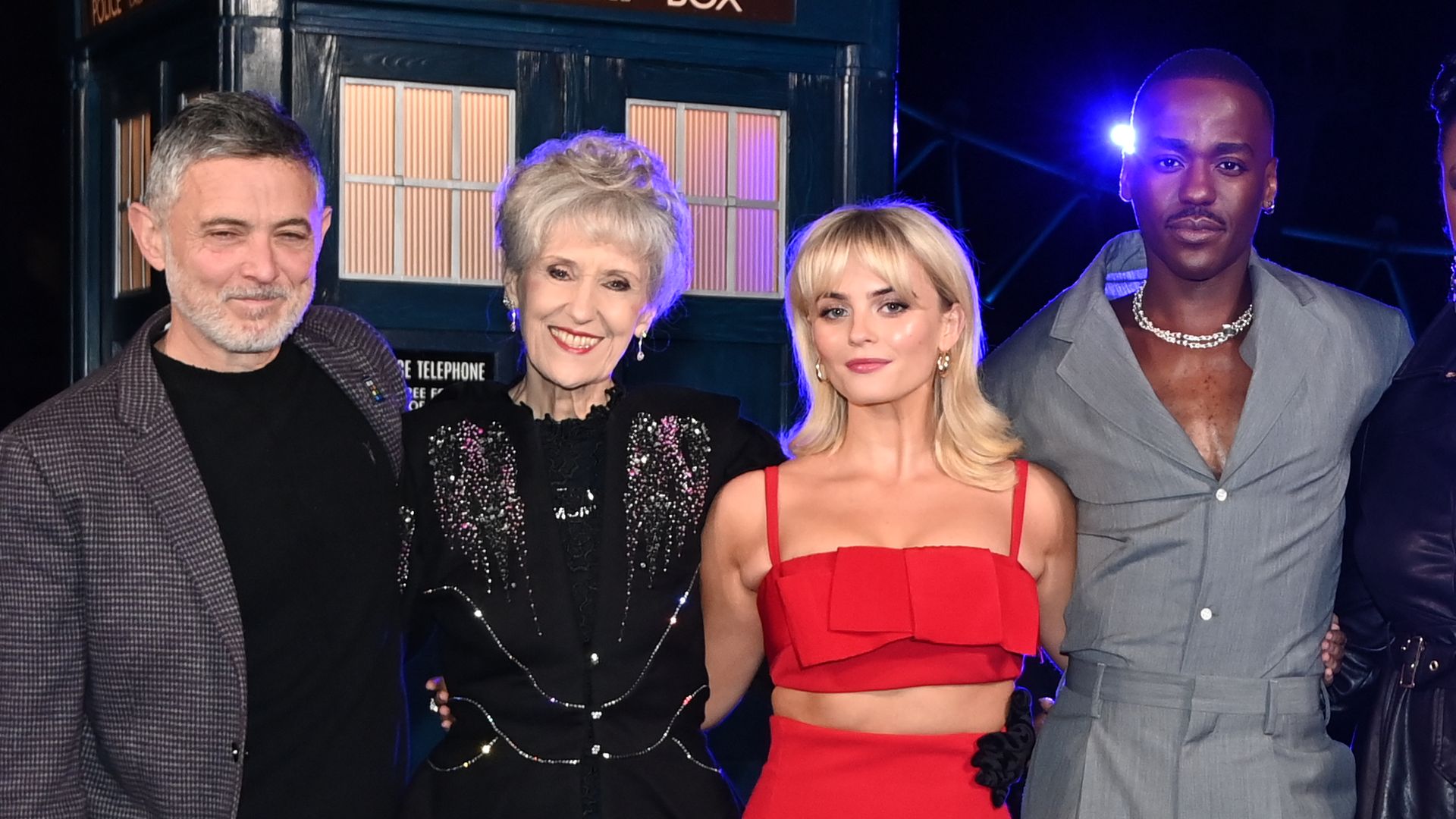 Alex Beaton, Anita Dobson, Millie Gibson, Ncuti Gatwa, Michelle Greenidge, Angela Winter, Russell T. Davies and Phil Collinson standing in a line