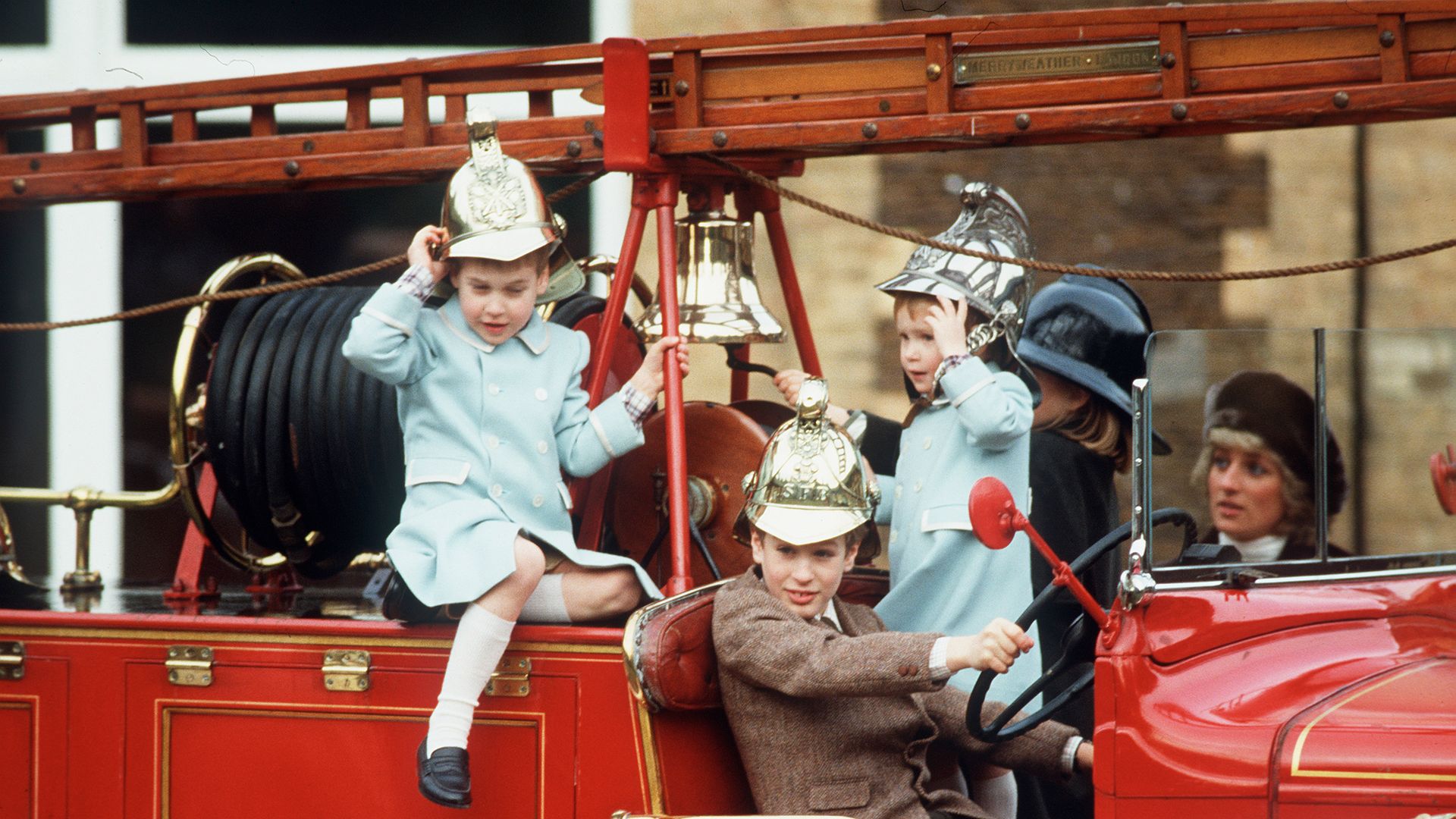 four children playing on fire engine 