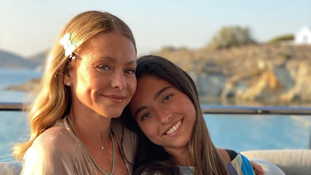 kelly ripa and daughter lola consuelos posing on a boat